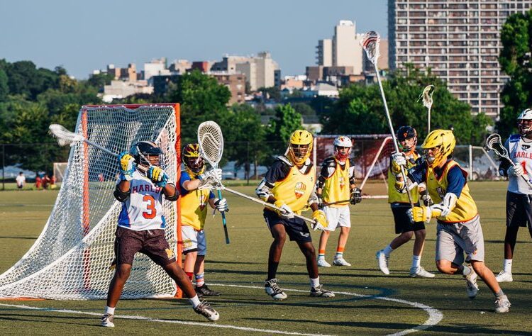 Students in Harlem playing lacrosse.