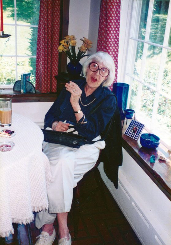 Helen Merrill sitting cross-legged.