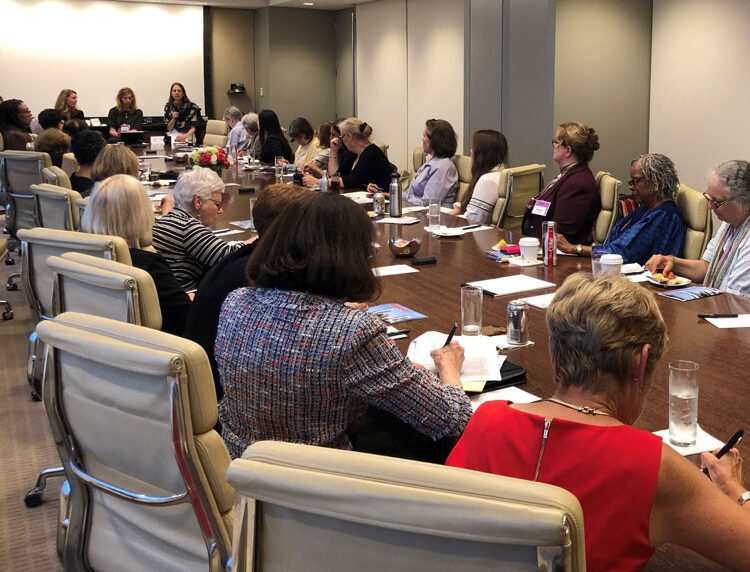 A group of women around a conference table