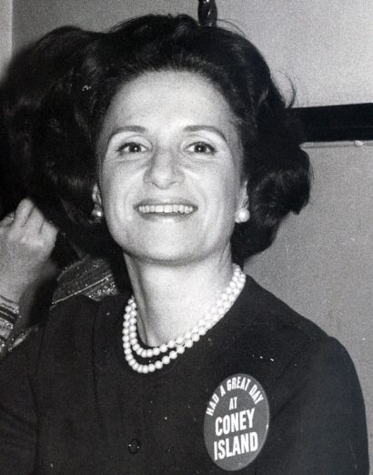 Joyce Matz smiling while wearing a “Had a great day at Coney Island” pin.