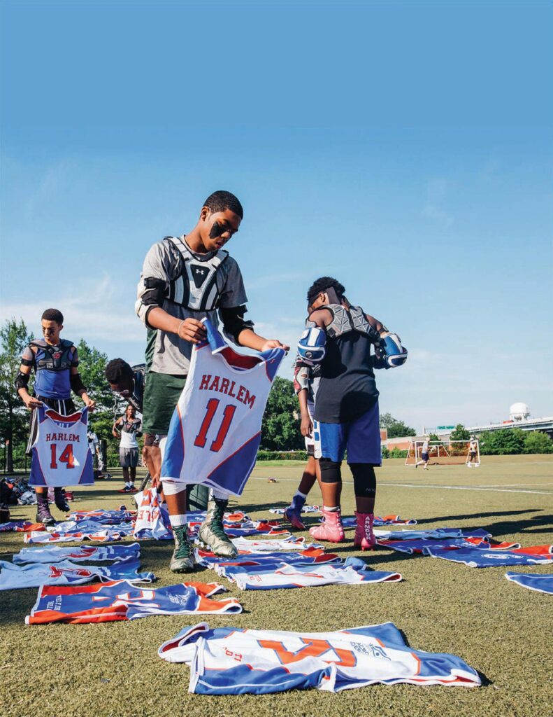 Harlem Lacross players hold their jerseys.