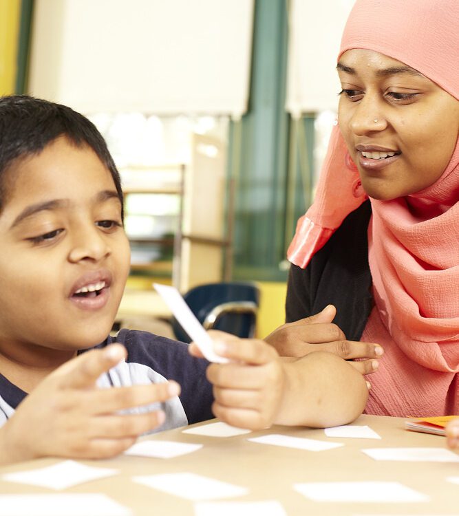 A child receiving instruction with flash cards