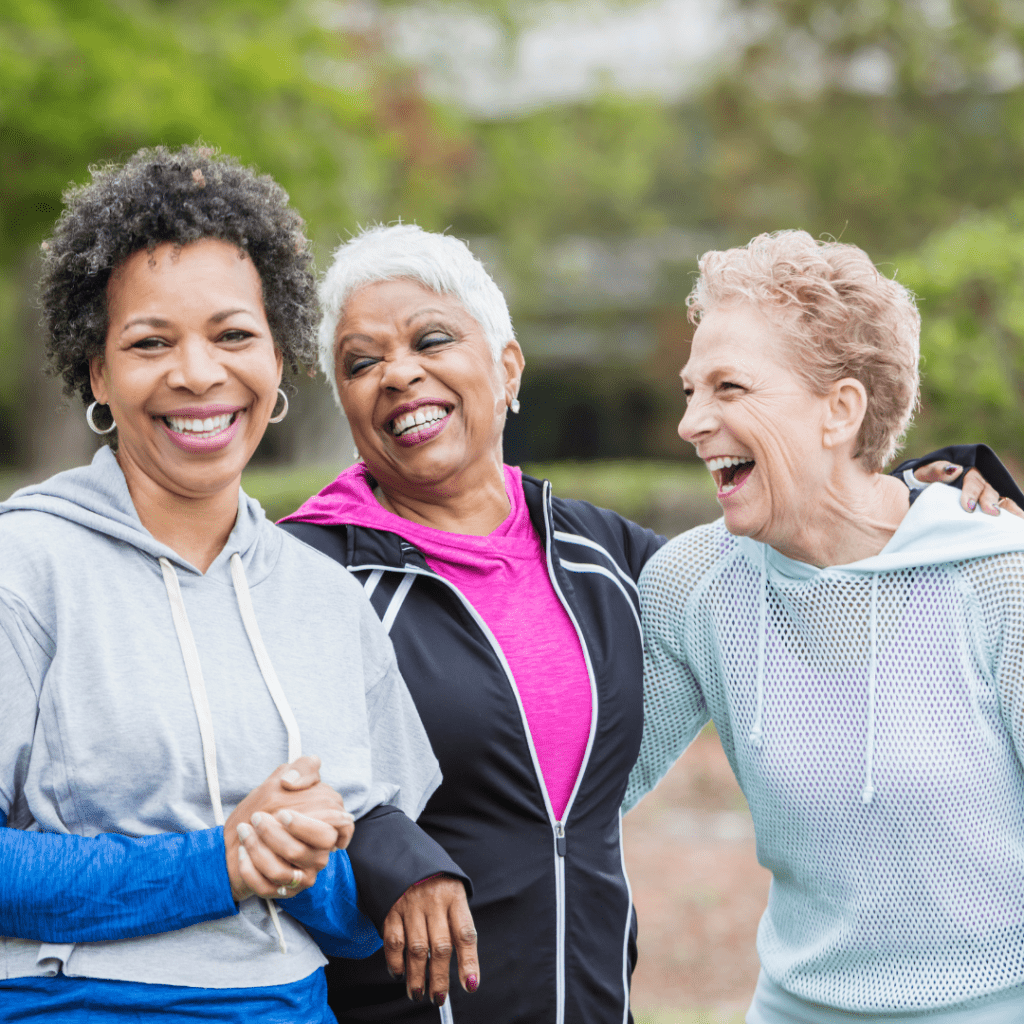 Three older women smiling and laughing