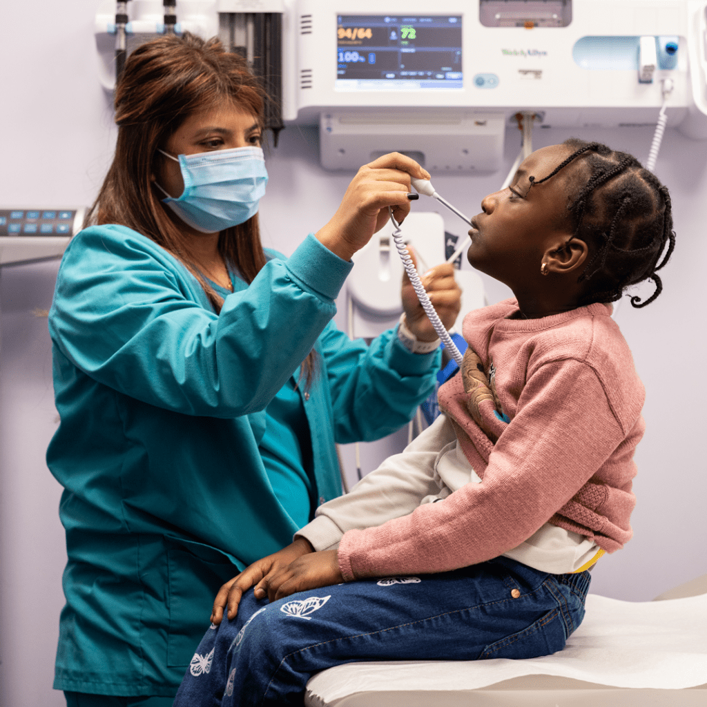 A child getting their temperature taken